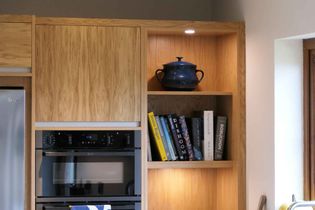 Close up of a bookshelf in modern oak kitchen