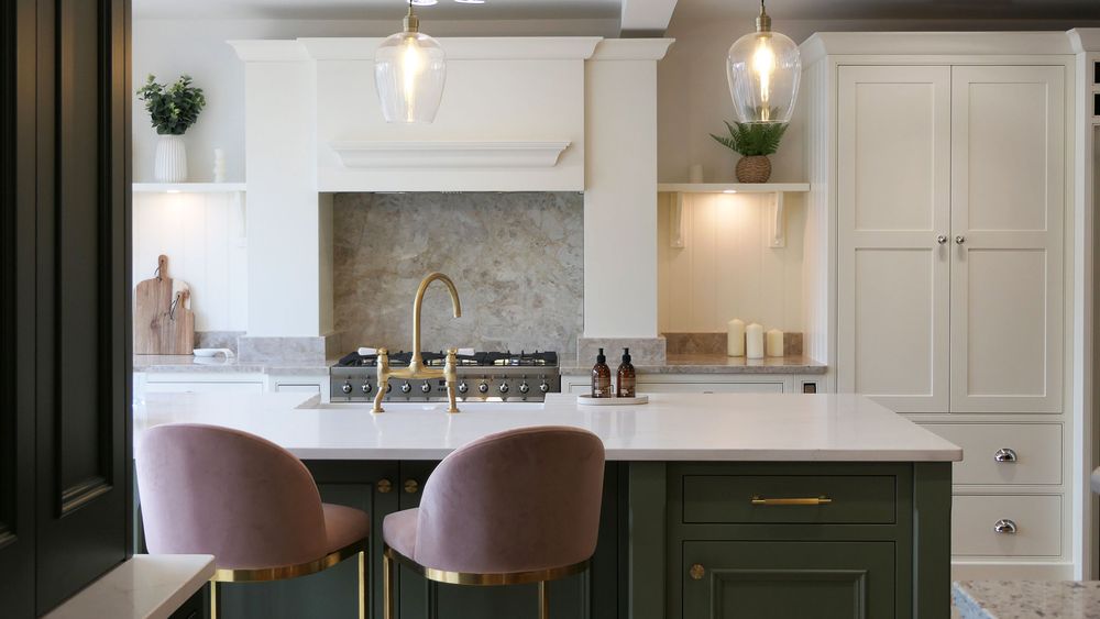  Cream Shaker kitchen with brass bridge tap and stone splashback in a Minerva showroom