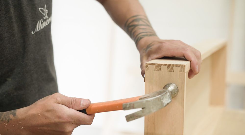 Craftsmen building a wooden drawer on a work bench