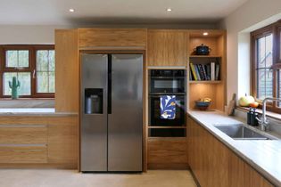 Close up of the fridge-freezer in modern oak kitchen
