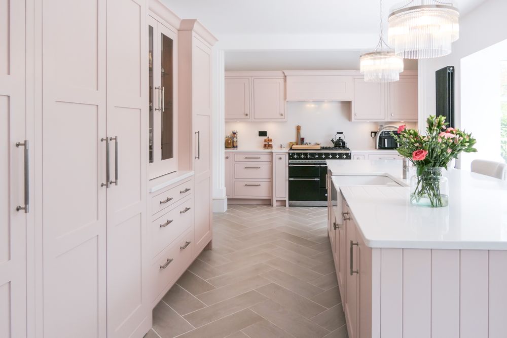 Pale pink Shaker kitchen with a large island
