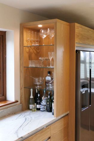 Integrated bar area with oak frame and glass shelving