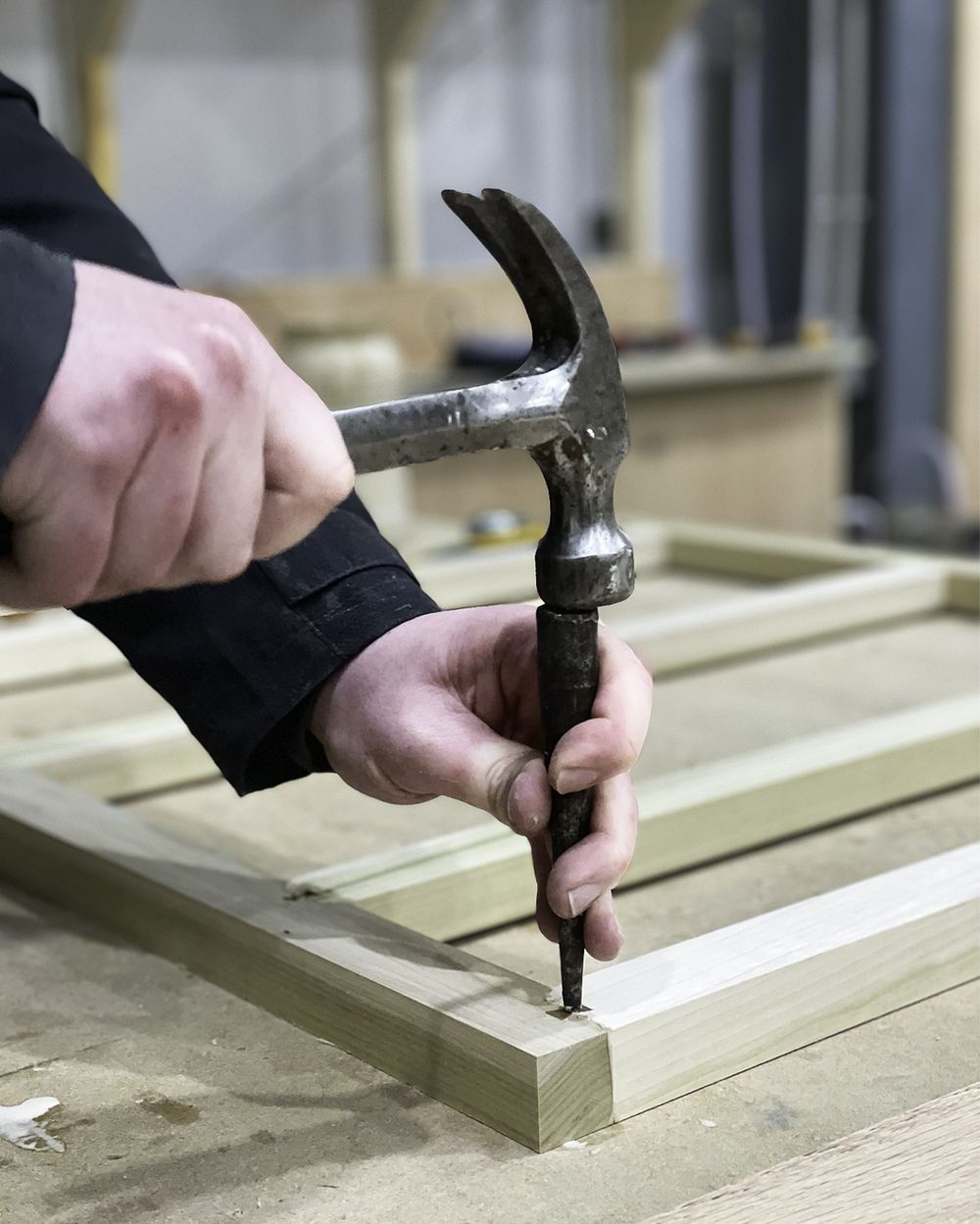 Cabinetmaker making a wooden frame with hand tools