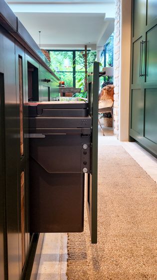 Integrated bin built into the kitchen island.