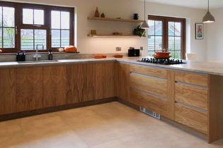 Modern oak kitchen with wooden shelving and hob on the right above pan drawers