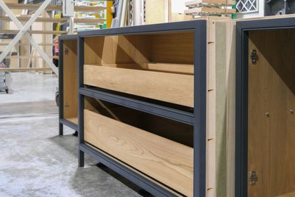 Painted cabinet carcass with oak-veneered interior under construction in the workshop