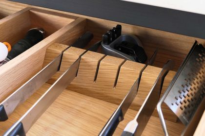 Oak drawer insert with a knife block and dividers, organising cutlery and utensils